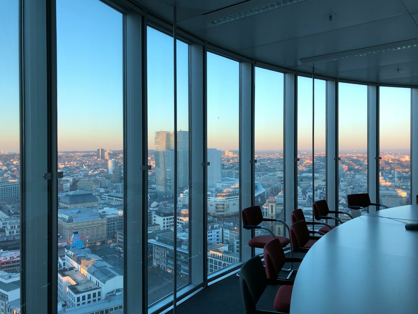 Empty conference room with city skyline view.