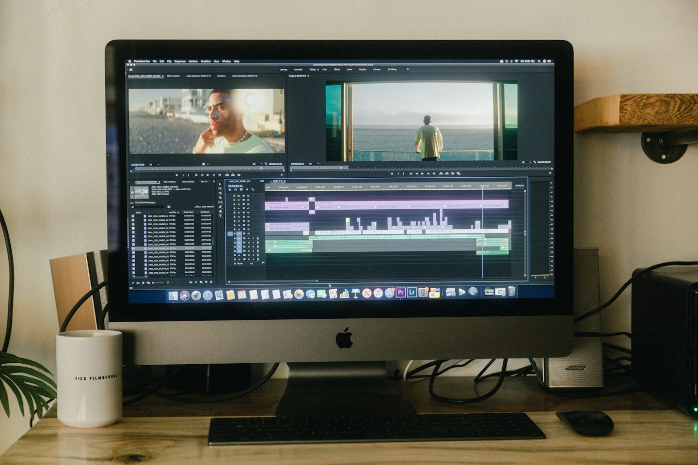 Person editing video on a computer with software open.